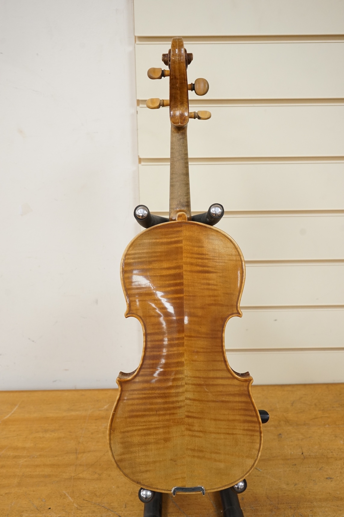 Five cased 20th century violins, including; a German violin, two Czech violins, a three-quarter size violin with a label for Bienfait, and a Romanian quarter size violin, all in cases or the remains of cases.